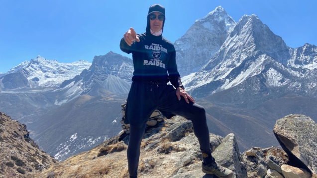 Everest keynote speaker climbing a fixed rope along the exposed summit ridge of Mount Everest