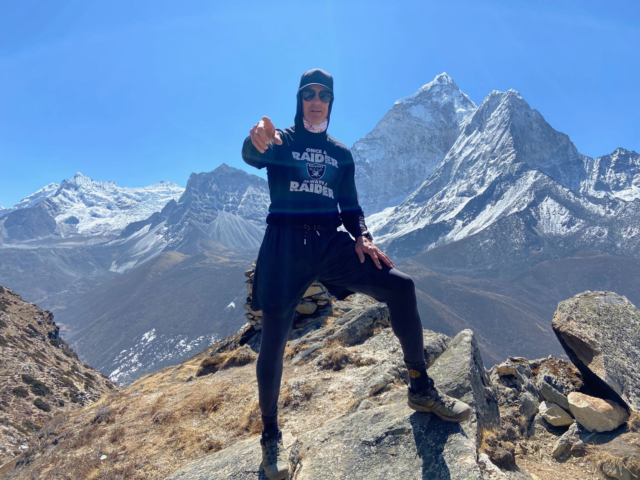 Everest keynote speaker climbing a fixed rope along the exposed summit ridge of Mount Everest